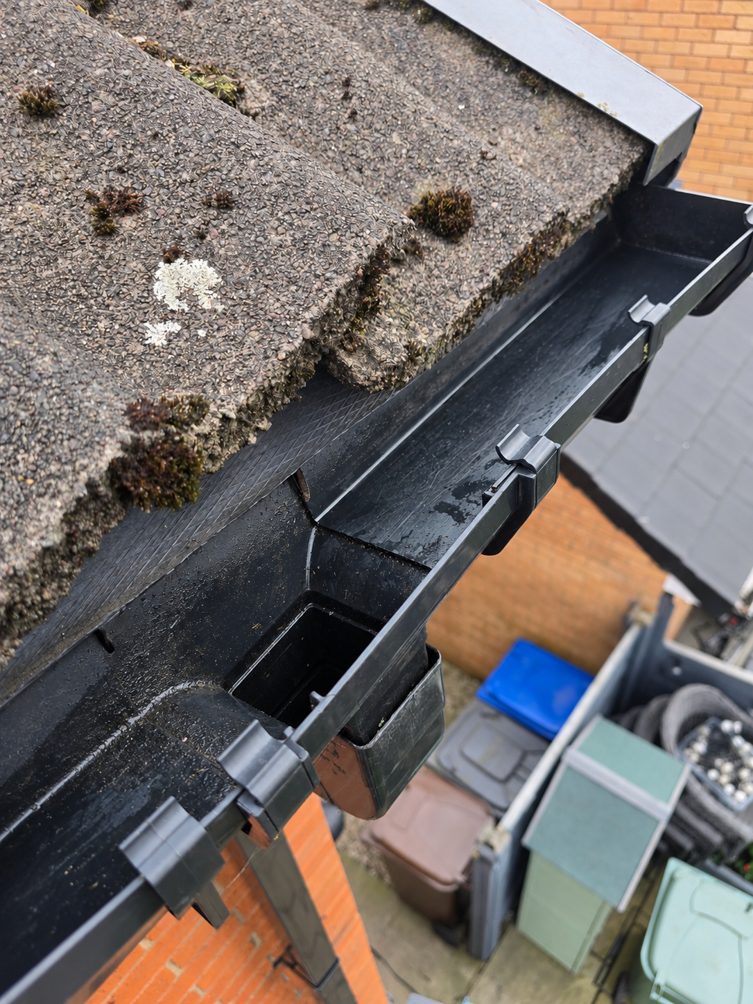 After: cleared gutter outlet; photo angle adjusted with AI