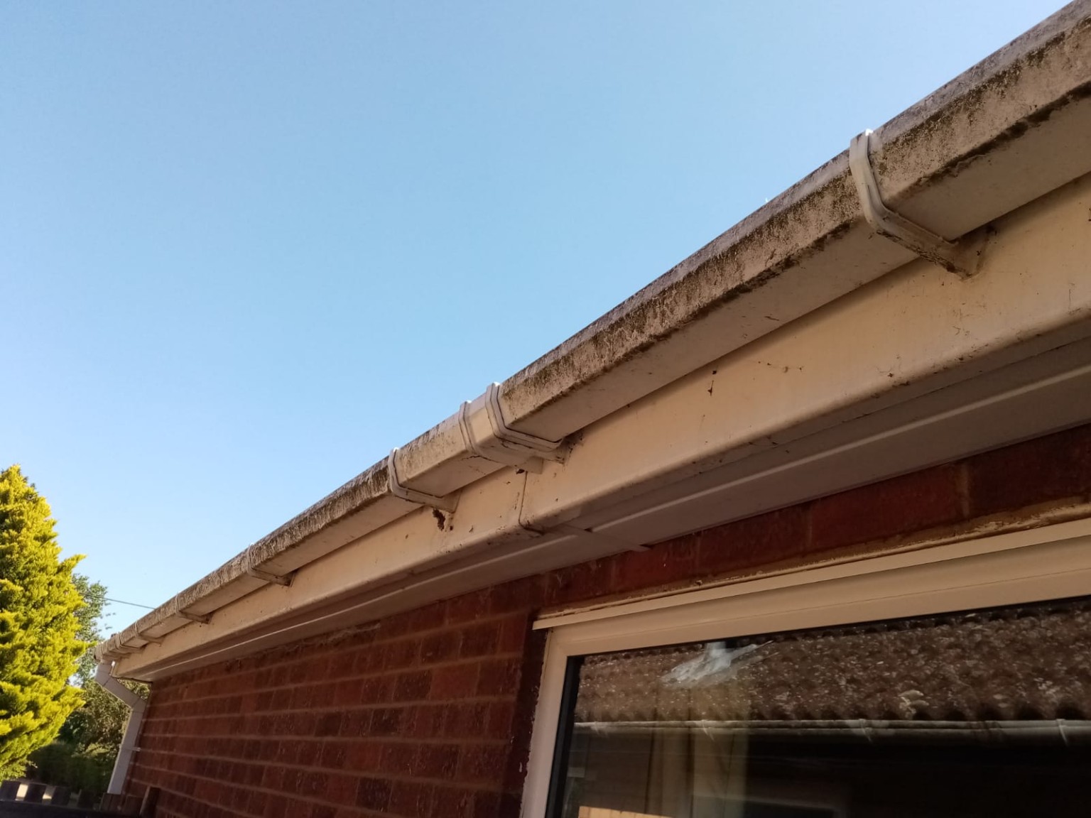 Before: dirt and staining on the gutter and fascia